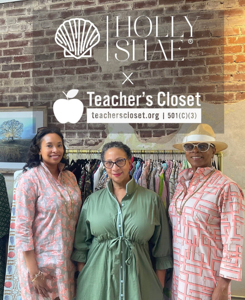 Three women standing in front of a clothing rack with 'Holly Shae' and 'Teacher's Closet' logos displayed.