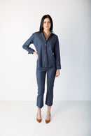 Woman wearing a blue long sleeve top against a white background