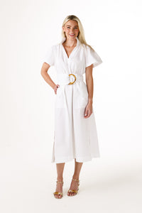 A woman modeling a white short sleeve dress with gold belt loop on a white background